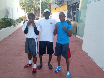 Clive Atwell left after his training session yesterday with trainer Lennox Daniels and training partner Leon Moore. 