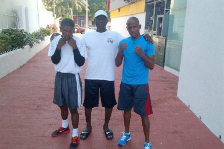 Clive Atwell left after his training session yesterday with trainer Lennox Daniels and training partner Leon Moore.
