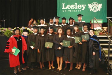 The graduates with Education Minister Priya Manickchand (fifth from right in front row) and university officials. (Ministry of Education photo) 