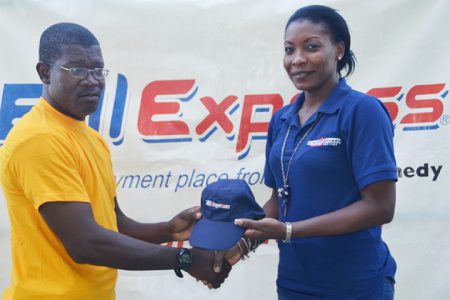 Marketing Representative of Western Union, Natheeah Mendonca hands over one of the caps to the Media XI captain Calvin Roberts.
