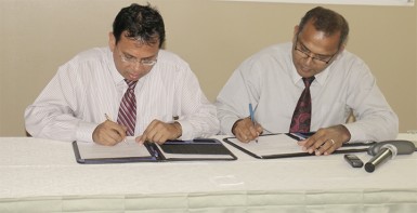 Culture Minister Frank Anthony and Radha Krishna Sharma, CEO of GT&T sign the $10 million MoU for the documentation of the National Collection. (Photo by Arian Browne) 