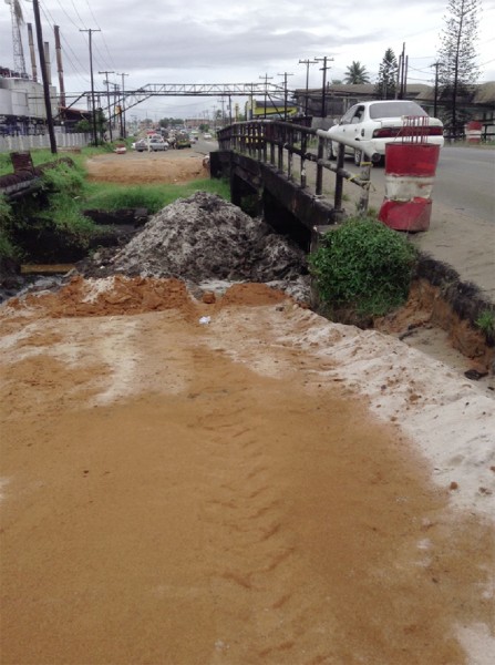 A section of incomplete road work on the East Bank Public Road by the BK Group. The ‘high bridge’ (shown) by Demerara Distillers Limited (DDL) is scheduled to be expanded on both sides. However, GT&T poles are hindering the commencement of the project, the contracting firm said. 