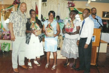 Minister in the Ministry of Finance, Juan Edghill (left) and GTU president, Mark Lyte (right) with three of the awardees