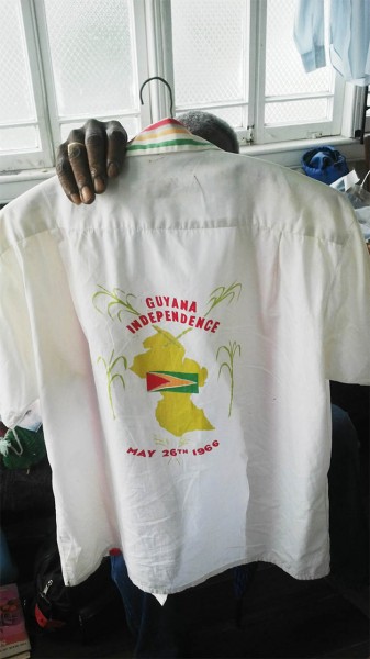 How many people can say they’ve kept a shirt for 48 years? The owner of the shirt in the photo above is 84-year-old Kitty resident, Yuli Gooding. It was made by the now defunct Windsor Shirt Factory that was located on the East Coast Demerara, in commemoration of Guyana’s independence. Gooding said it was bought sometime between the May 22 and May 24, 1966; he cannot remember what the price was. He said he and quite a few others wore their Independence shirts on the first flag raising night. (Photo by Dacia Whaul) 