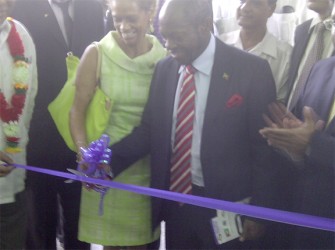 St. Kitts and Nevis Prime Minister Denzil Douglas along with Dr. Anne-Marie Irvine Smith, wife of the CDB President Warren Smith, cutting the ribbon to formally open the new Tuschen Nursery School. 