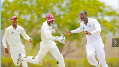 Sagicor WI HPC captain Kraigg Brathwaite, left, wicketkeeper Chadwick Walton and seamer Carlos Brathgwaite, right celebrate another Bangladesh A wicket on the second day of the first four day match between the two sides at the Windward Sports Club. (Photo by WICB media/Randy Brooks of Brooks/La Touche photography. 