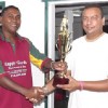 Captain of the Everest Masters Rajesh Singh (right) collects the winning trophy from Enterprise skipper Seemangal Yadram.
