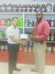 CEO of Fitness Express, Jamie McDonald hands over the sponsorship cheque to Erwyn Smith. 