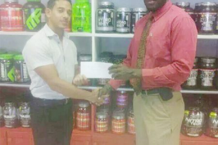 CEO of Fitness Express, Jamie McDonald hands over the sponsorship cheque to Erwyn Smith.

