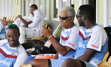 Sir Garfield Sobers speaks to Kemar Roach and Sulieman Benn during a training session for the West Indies team at the 3Ws Oval at the Cave Hill Campus of the University of the West Indies in Barbados earlier this week. (Photo WICB Media Philip Spooner) 
