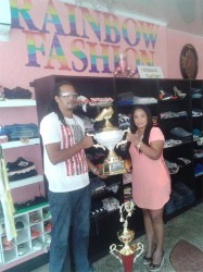 Organiser Richard receiving the winner’s trophy from Shellon August of Rainbow Fashion