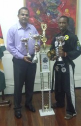 Martial Arts Hall of Famer Roland Eudoxie posing with Minister of Culture, Youth and Sports Dr. Frank Anthony. 