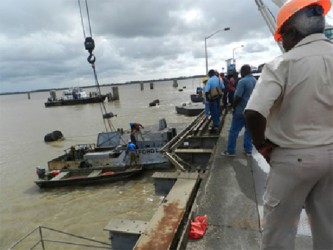 Minister Robeson Benn (backing camera) looking on as the Rickford L is retrieved. (Photo by Aneka Edwards/ Ministry of Public Works) 