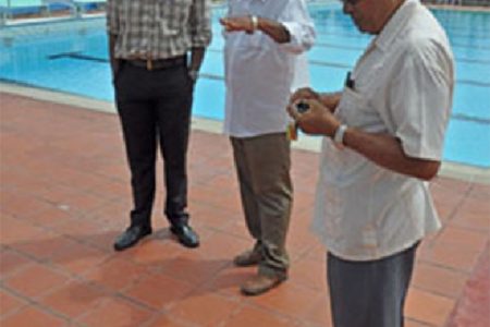 APNU MP Christopher Jones (left) inspects the pool-area with the assistance of PPP/C MP and Director of Sport Neil Kumar
