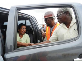 General Manager of the DHB Rawlston Adams and Minister Robeson Benn meeting Roopchand’s wife after the accident. (Photo by Aneka Edwards/Ministry of Public Works) 