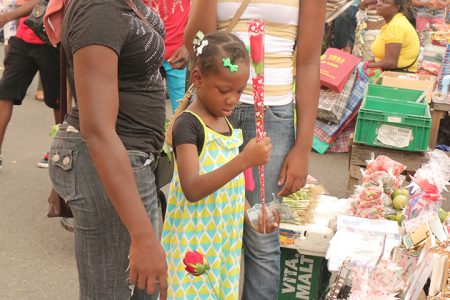 This girl was deciding yesterday on a rose for her mother at the Stabroek Market.