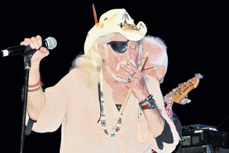 Lead singer Ray ‘Eye Patch’ Sawyer of Dr Hook takes a smoke during his performance at To Mom With Love concert at LIME Golf Academy in New Kingston on Sunday.