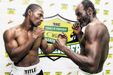 Kevin ‘Bus Boy’ Hylton (left) of Team Jamaica stares down his opponent Howard ‘Batter Tea’ Eastman of Team Caribbean ahead of today’s fight.