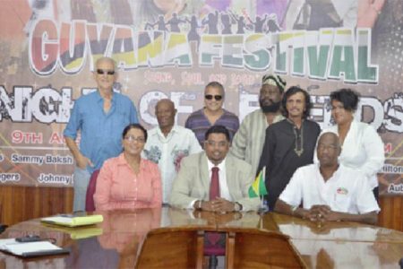 Minister of Tourism, Industry and Commerce (ag) Irfaan Ali (sitting at centre), Lennox Canterbury (sitting at right), Coordinator of the Night of the Legends and Tameca Sukdeo-Singh (sitting at left) and some of the artistes to perform at Night of Legends at the Guyana Festival.  (GINA photo)