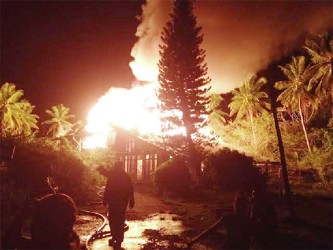 Fire fighters trying to put out the fire on Friday night. (Photo courtesy of Manuel Barnwell) 