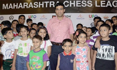 Grandmasters of the future? Former world chess champion Vishy Anand is pictured with some youngsters who, perhaps, represent India’s chess future. Anand was a guest at the 2014 Maharashtra Chess League (MCL) players’ auction. The MCL represents the only professional chess league in India and is similar to the popular IPL in cricket. The initial tournament was held last year. The MCL is a unique tournament with a bidding process by private sponsors to determine the composition of each team. Some top Indian chess players were up for sale to the highest bidders.