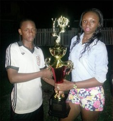 Future’s skipper Keron Solomon receiving the winning trophy from August Beverage sale representative Annastatia Lewis.