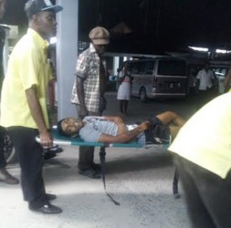 The unidentified man as he was being rushed into the hospital last night.