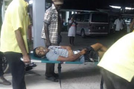 The unidentified man as he was being rushed into the hospital last night.