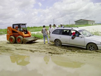 A Stabroek News vehicle being set up for a tow by workers of Beesons Windows and Doors. 