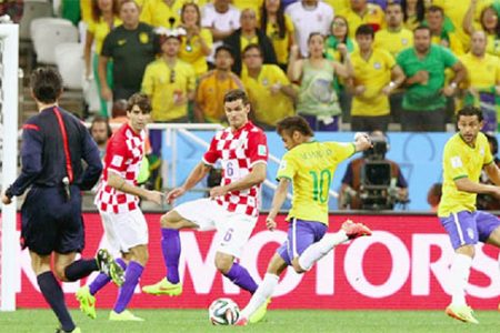 Neymar of Brazil shoots and scores against Dejan Lovren of Croatia in the first half during the 2014 FIFA World Cup Brazil Group A match between Brazil and Croatia at Arena de Sao Paulo yesterday in Sao Paulo, Brazil. (Photo by Adam Pretty/Getty Images)