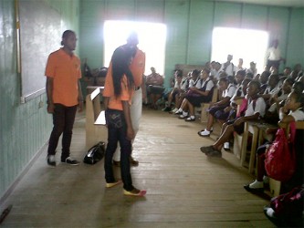 Actors presenting a scene on gender-based violence to students of a rural school. (Photo courtesy of Merundoi.)