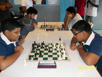 Brothers and twins! Christian and Carsen Shiwrattan, both students at Bishop’s High School, engage each other in a warm-up chess game before the ECI sponsored tournament begins. The brothers are relative newcomers to the Georgetown chess scene, but demonstrated enthusiasm during their separate encounters. They expressed an interest in having a greater number of games played during tournaments.