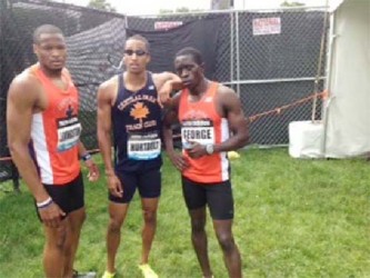 Winston George (right) poses with his club teamates after his record 400m run in New York Yesterday.              