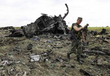 Pro-Russian separatists walk at the site of the crash of the Il-76 Ukrainian army transport plane in Luhansk yesterday. (Reuters/Shamil Zhumatov)