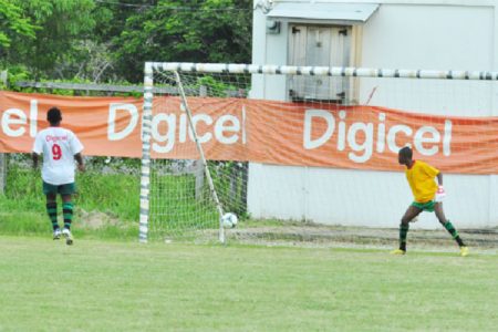 Quincy Lawrence of St. George’s High dispatching the winning penalty kick to seal the win for his team over Dolphin Secondary
