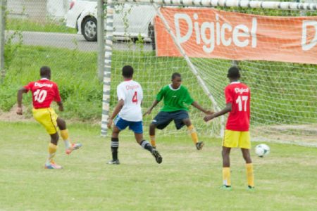 South Ruimveldt Secondary’s Keith Caines (no.10) in the process of scoring one of his four goals during his side’s 9-1 victory over Christ Church Secondary.