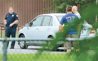 Police at the scene of the discoveries on Monday. Pictured is the vehicle that contained the dead bodies 32-year-old Allison Pluck and her two daughters, Shania and Shameka Gill (Herald Mail photo) 