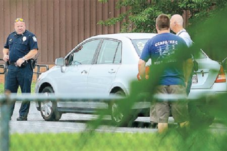 Police at the scene of the discoveries on Monday. Pictured is the vehicle that contained the dead bodies 32-year-old Allison Pluck and her two daughters, Shania and Shameka Gill (Herald Mail photo)
