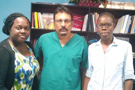 Dr. Jeetendra Mohanlall (centre) stands with two members of his TB team. TB DOTS Prison Supervisor Gerilyn Mc Kenzie (left) and Dr. Phenila Rogers.
