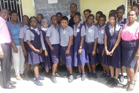 The top students pose with Deputy Head Deryn Moore-Heyligar (middle) and Grade Six teachers on each end.