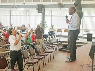 Student Glenfield Denison faces off with Vice-Chancellor Jacob Opadeyi (right) during the consultation yesterday