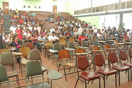 Students listen to Vice-Chancellor Jacob Opadeyi and other presenters during the consultation. Not many students were in attendance initially but the number grew as more and more trickled into the George Walcott Lecture Theatre at the Turkeyen Campus yesterday  