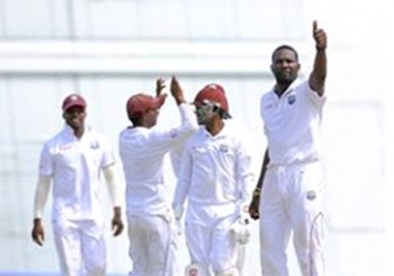Left-arm spinner Sulieman Benn (right) celebrates another five-wicket haul with the home crowd yesterday. (Photo courtesy WICB Media) 