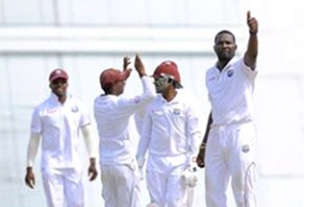 Left-arm spinner Sulieman Benn (right) celebrates another five-wicket haul with the home crowd yesterday. (Photo courtesy WICB Media) 