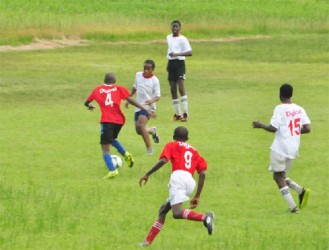 Brickdam Secondary’s Malachi Adonis (No.4) attempting to evade his Central High School marker during his side’s crushing win