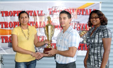 Petal Badrie of the Trophy Stall presents one of the trophies up for grabs in Sunday’s tournament to BVA Treasurer/Competition Director Godwyn Allicock.  