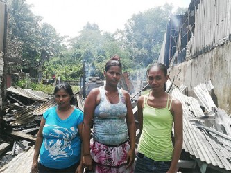 Fire victims from left to right, Nariman Khalil, Rafeena Rasheed and Monett Tony stand in front of the place they once called home.
