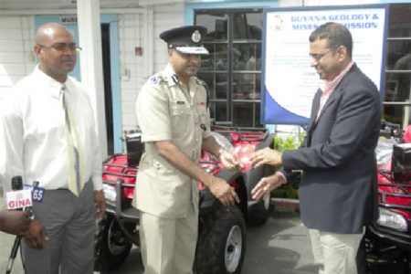 A symbolic handing over by Minister of Natural Resources Robert Persaud (right) to Commissioner of Police, Seelall Persaud. Also in photo is Commissioner of the GGMC, Rickford Vieira. (Ministry of Natural Resources photo)
