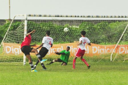 Chase Academy’s Isiah Reddy (left) in the process of securing his team’s fifth goal