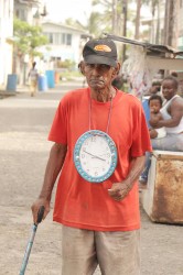 This Albouystown man was walking about today with this clock hanging from his neck.